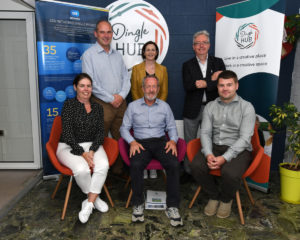 Seán Kelly with ESB Networks representatives and Deirdre from Dingle Hub seated in front of Dingle Hub and ESB signage